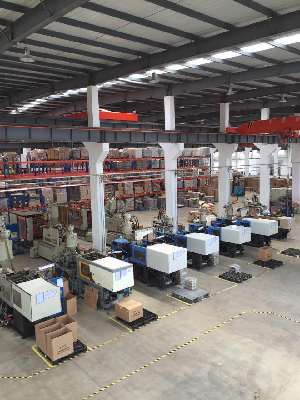 Factory workshop with production equipment and overhead cranes